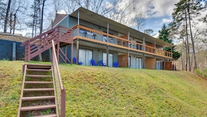 A modern multi-story building with a wooden staircase leading up to a balcony, surrounded by trees. - 3-unit Combo w/ Dock on Lake Keowee - Hike & Fish! (Seneca)