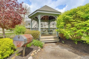 A gazebo with a roof and steps, surrounded by greenery and a barbecue grill. - Walk to Holiday Valley Pool & Lifts! Family Escape (Ellicottville)