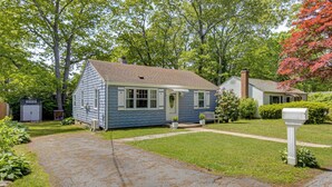 A single-story house with a front porch, a driveway, and a mailbox. - < 1 Mi to Sand! Updated Cottage w/ Yard in Niantic (Niantic)