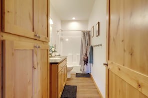 A wooden bathroom with a shower, toilet, and sink. - Mtn Views! Canon City Duplex Near Town & Riverwalk (Canon City)