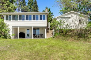 A two-story house with a covered porch and a separate garage.