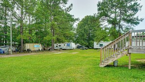 A campground with RVs, a wooden deck, and a grassy area. - Golf, Beaches & More! Pet-friendly Home in Leland (Leland)