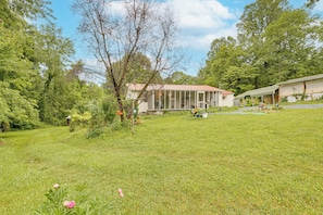 A house with a covered porch, a fenced yard, and a small shed. - Walk to Town: Fayetteville Retreat w/ Hot Tub! (Fayetteville)