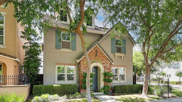 A two-story house with a brick entrance, green shutters, and a well-maintained lawn. - Spacious + Pet-friendly Family Home in Tracy (Tracy)