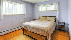 A bedroom with a bed, two bedside tables, a window with blinds, and a ceiling light fixture. - Extended-stay Home/office, 8 Mi to Dtwn Denver (Lakewood)