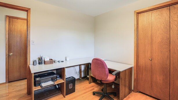 A room with a desk, chair, wooden wardrobe, and a ceiling light fixture. - Extended-stay Home/office, 8 Mi to Dtwn Denver (Lakewood)