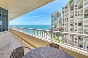 A balcony with a view of the ocean and adjacent buildings. - Beachfront Condo w/ Wide Balcony in Marco Island! (Marco Island)