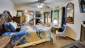 A bedroom with a bed, a chair, a desk, a ceiling fan, and a television. - 13 Miles to Arrowhead Stadium! Bbq-ready Home Base (Kansas City)