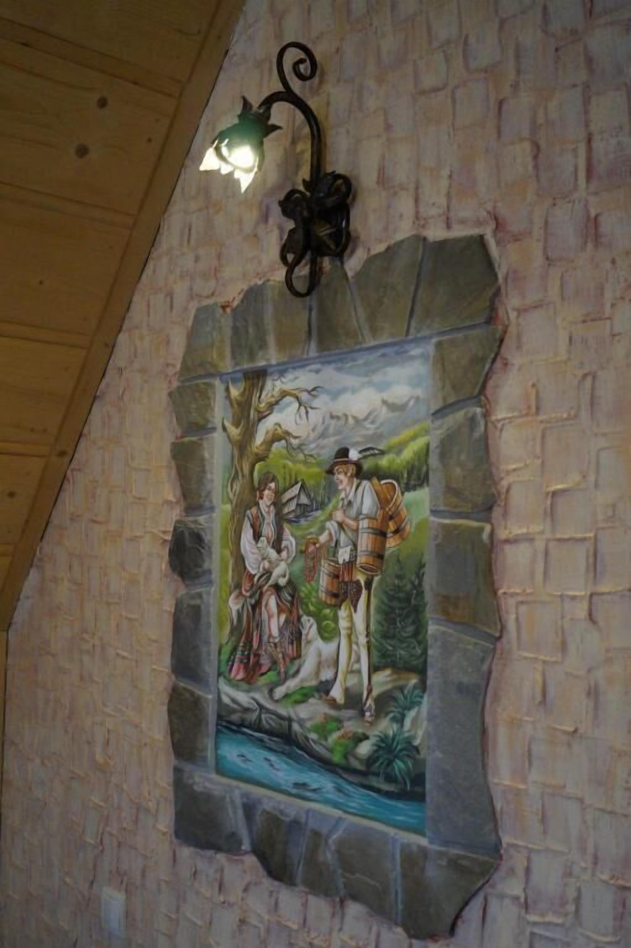 A mural with a stone wall and a hanging light fixture.