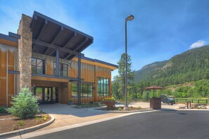 A modern building with large windows, a stone facade, and a parking area with a street lamp. - New Listing! Cliffside Studio | AC, Pool, Hot Tub, Golf & Ski (Durango)