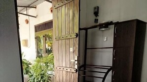 A room with a bed, a wooden wardrobe, and a door leading outside. - Step Inn Ahangama  (Ahangama)