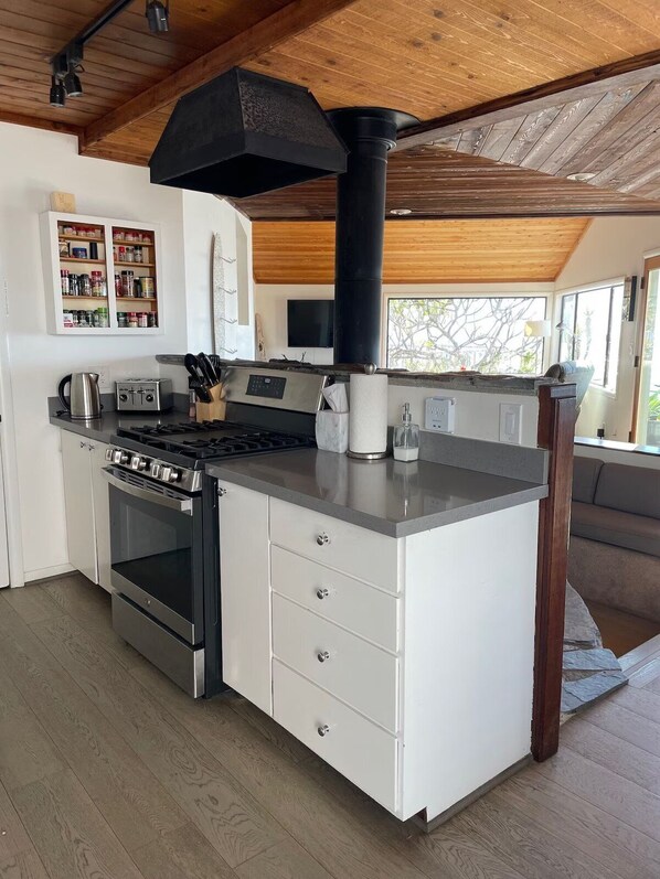 A modern kitchen with a central island, built-in oven, and a large black range hood. - 25% Off Sept 18&19! Water Front Perfect 4 Families (Ventura)