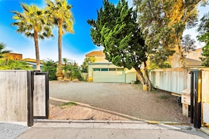 A gated driveway leading to a residential property with a garage and a house. - Oceanfront Retreat, Amazing Ocean Views W/Jacuzzi! (Ventura)