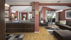 A modern kitchen with a central island, a dining area with a sofa and chairs, and a living room with a couch and a coffee table. - Apartment Valentino 5 with shared Pool (Ližnjan)