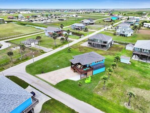 A residential area with houses, a road, and a small body of water. - Beach Retreat: 3  BR, 2  BA House in Crystal Beach, Sleeps 12 (Crystal Beach)