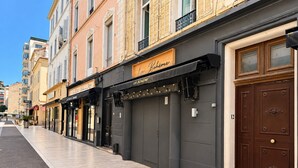 A row of buildings with storefronts, including a restaurant named 'La Bohème' with a black awning. - MIMOSAS 1 Air-conditioned near Croisette (Cannes)