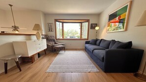 Ein Wohnzimmer mit einer Couch, einem Sessel und einem kleinen Tisch.