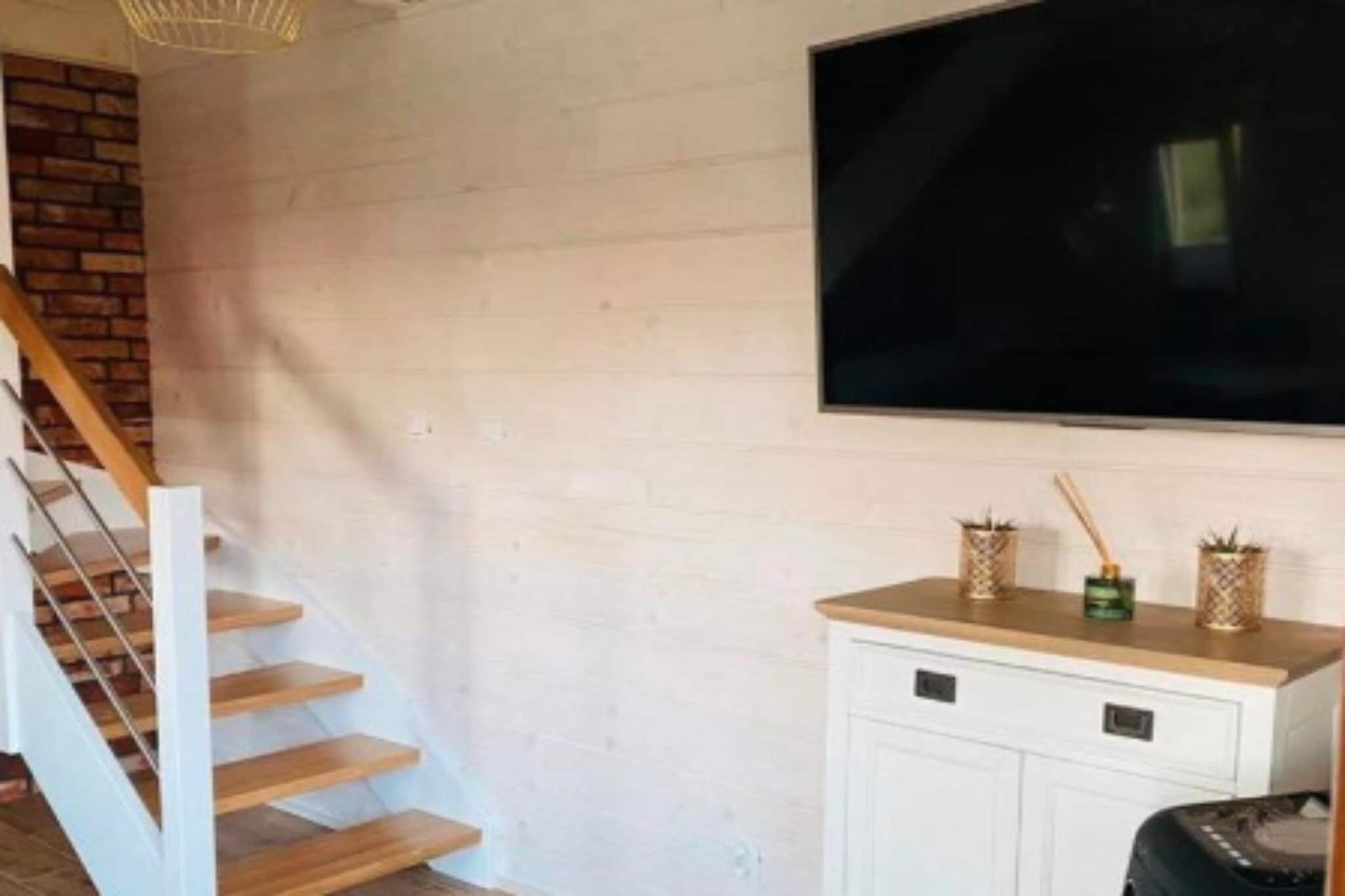A staircase with wooden steps and a white wall.