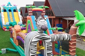 An inflatable playground with various structures including slides and climbing areas. - Air-conditioned holiday homes with swimming pool (Mielno)