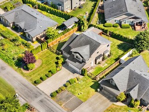 Vue aérienne d’un quartier résidentiel avec des maisons, des pelouses et une route.