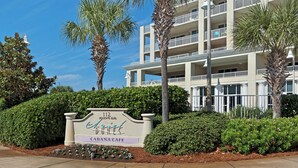 A sign for 'Ariel Suites' with a 'Cabanas Cafe' below it, in front of a multi-story building with balconies. - 🏖️Gulf + Pool Views | Walk to Beach | 2BR Ariel Dunes I 609 🏖️ (Miramar Beach)