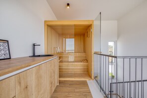 A wooden staircase leading to a higher floor, a reception desk, and a window with a view. - Villa Flokica with Heated Pool (Maslenica)