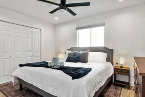 A bedroom with a bed, a nightstand, a ceiling fan, a window, and a wardrobe. - POOL + DECK OASIS - 8 Minutes from Zilker (Austin)