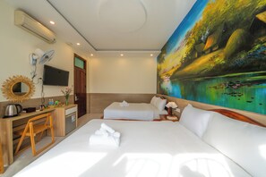A hotel room with a bed, a desk with a chair, a TV, and a painting on the wall. - New Moon Villa (Hoi An)
