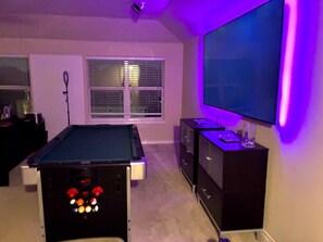 A pool table, a television, and a cabinet in a room with a window and blinds. - Trunks up! Spacious 3-bd house close enough for fun,far enough for peace & quiet (Lancaster)