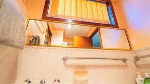 A bathroom with a mirror, a towel rack, a soap dish, and a hand dryer. - Spacious Three-bedroom Holiday Home With the Entire House Exclusively Yours (Sanctuary Point)