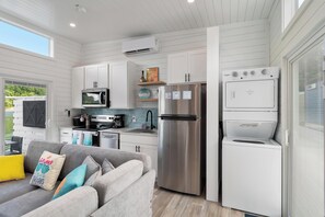 A compact kitchen with white cabinetry, a stainless steel refrigerator, a microwave, and a built-in oven. - Tequila Sunrise - Relaxing Getaway Lake Cumberland (Russell Springs)