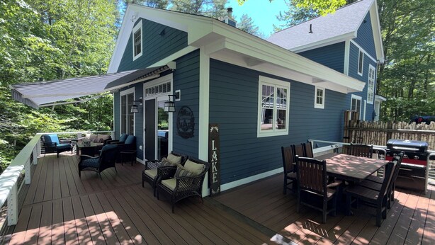 A house with a deck, outdoor seating, and a barbecue area. - Welcome to the Bear’s Den. A Delightful house on Lake Winnipesaukee in Meredith. (Meredith)