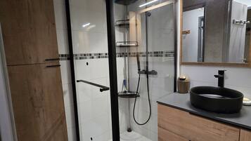 Shower, hair dryer, towels, toilet paper