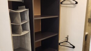 A closet with multiple shelves and hanging space, a door with a handle, and a tiled floor. - Newly Remodeled Loft - Fast WiFi - A/C - 9 Min drive to Malecon (La Paz)