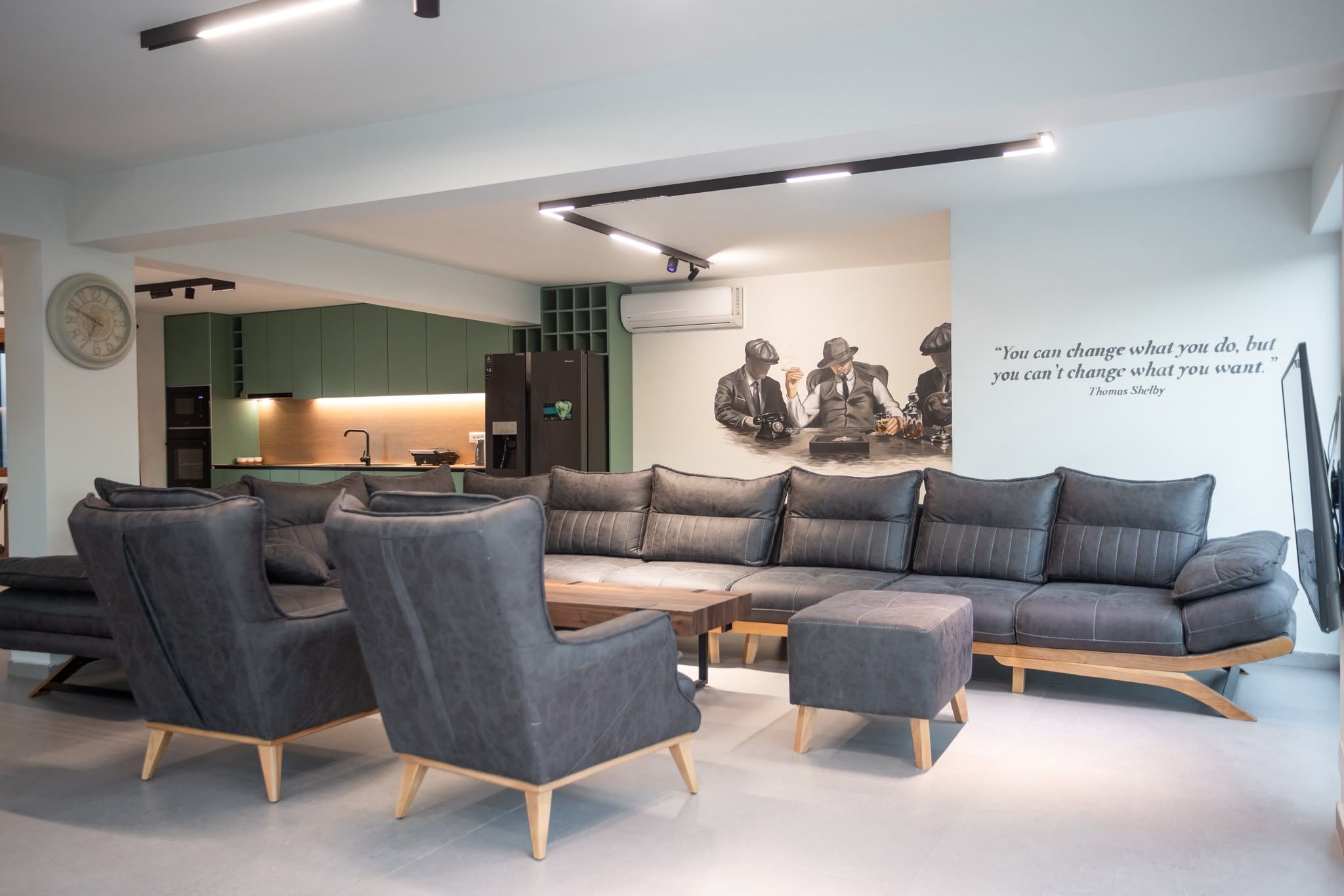 A modern living room with a sectional sofa, armchairs, and a coffee table.
