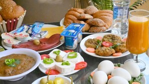 A breakfast spread with various foods and drinks. - Pyramids Wonders Hotel (Giza)