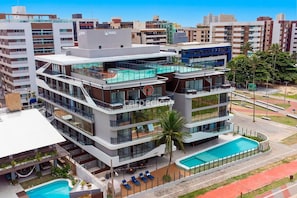 A multi-story hotel with a rooftop pool, balconies, and a swimming pool. - Azimut With Direct Beach Access and Sea View by Carpediem (Cabedelo)