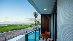 A balcony with a pool, a table, and chairs. - Azimut With Direct Beach Access and Sea View by Carpediem (Cabedelo)