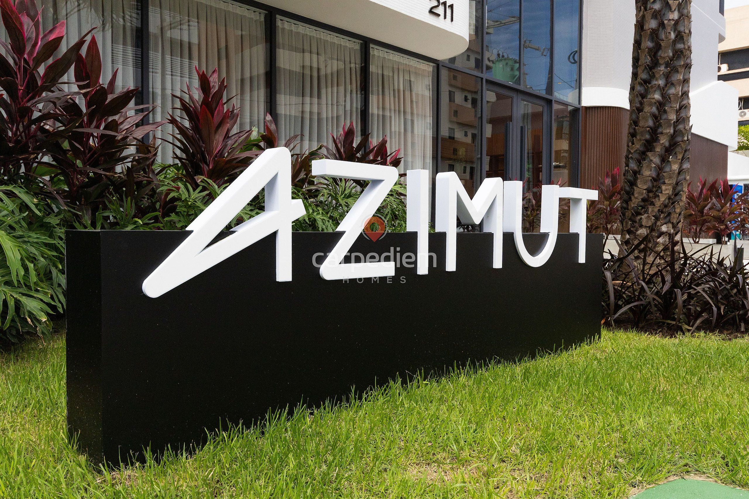 A sign for 'AZIMUT HOMES' with a modern building in the background.