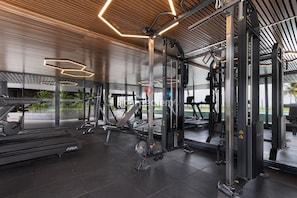 A gym with exercise equipment, large windows, and a wooden ceiling. - Azimut With Direct Beach Access and Sea View by Carpediem (Cabedelo)