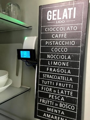 A menu board listing gelati flavors in a restaurant.