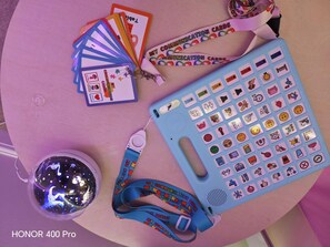 A table with a globe, communication cards, a lanyard, and a badge holder.