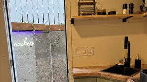 A kitchen with a built-in sink, wooden countertop, and cabinets. - The Green Clover Hideaway-Cozy Studio Retreat with Fire Pit (Draper)