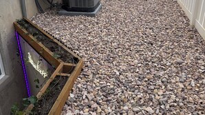 A rooftop with a gravel patio, outdoor air conditioning unit, and a small garden bed with a neon sign. - The Green Clover Hideaway-Cozy Studio Retreat with Fire Pit (Draper)