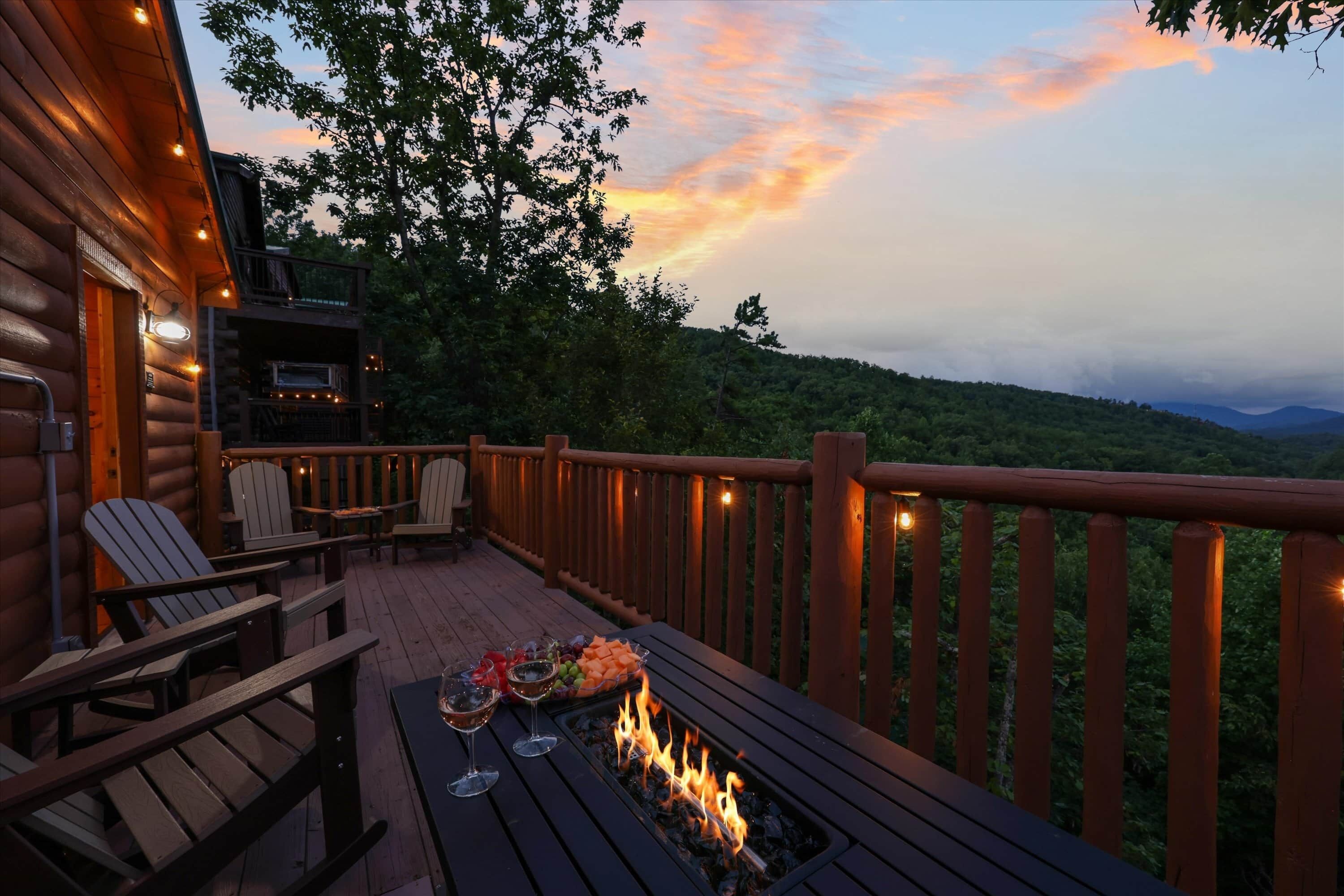 A wooden deck with outdoor seating and a fire feature.