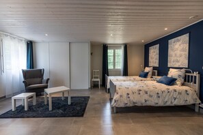 A bedroom with two beds, a chair, a small table, and a window. - La bergerie - ESCALANS (ESCALANS)