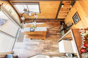 A wooden interior with a central table, a ceiling light, and a sign reading 'B&B.' - Quiet Cul-De-Sac, Walk to SHARC w/ free passes, Hot Tub, AC, Sleeps 13! (Sunriver)