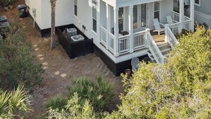 A multi-story building with a balcony, a water tower in the background, and surrounding vegetation. - ~Villa Blanca~ Rooftop! Best Location on 30A~Alys~Seacrest~Rosemary Beach (Panama City)