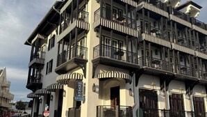 A multi-story building with balconies, a clock, and a sign reading 'Havana Beach.' - ~Villa Blanca~ Rooftop! Best Location on 30A~Alys~Seacrest~Rosemary Beach (Panama City)