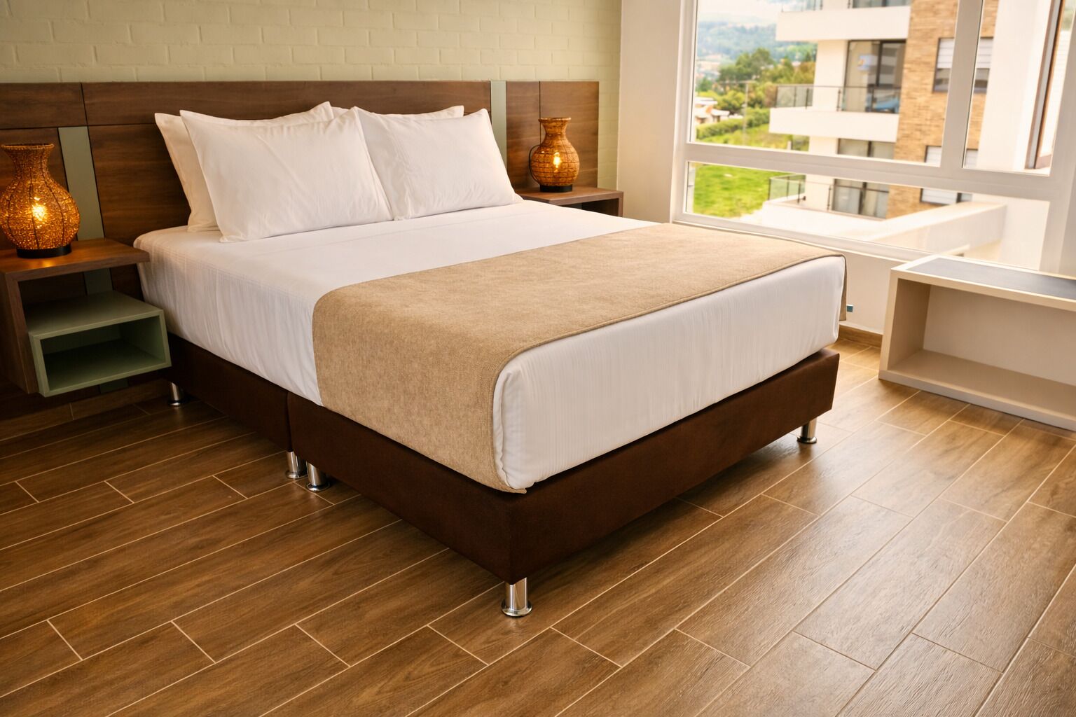 Habitación de hotel con una cama grande, piso de madera, vista al exterior y una pared de ladrillo.